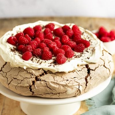 chocolate pavlova with cream and raspberries
