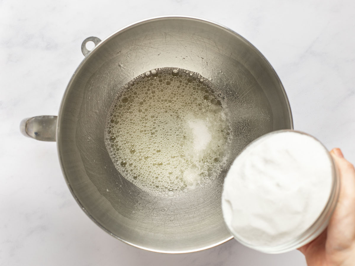 adding sugar to frothy egg whites.
