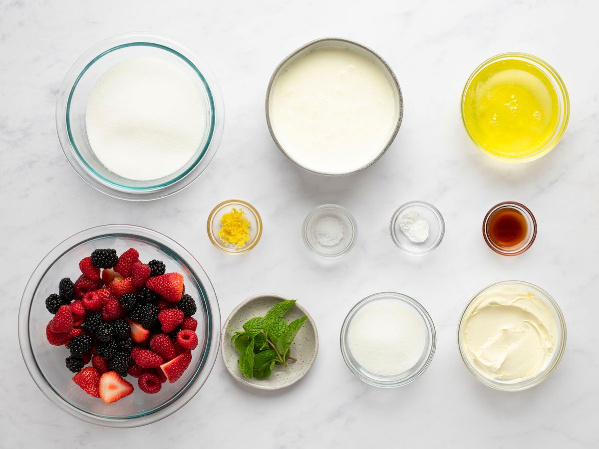 Ingredients to make a classic pavlova in bowls on a countertop.