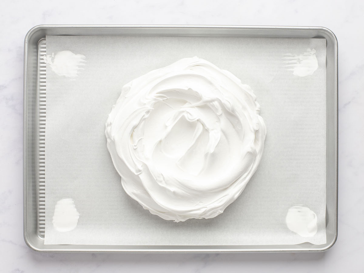 meringue mounded onto parchment-lined baking sheet