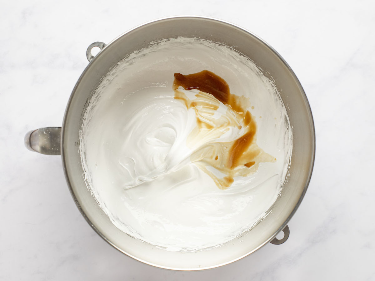 meringue in mixing bowl with vanilla and cornstarch added