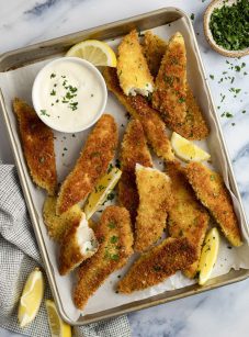 pan fried fish fingers on baking sheet with garlic lemon mayo