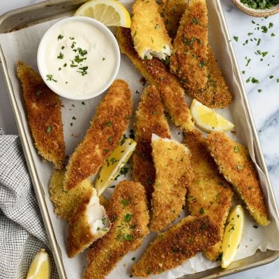 pan fried fish fingers on baking sheet with garlic lemon mayo