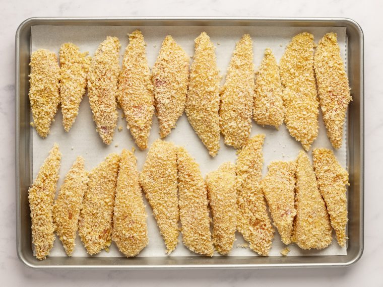 breaded fish on baking sheet