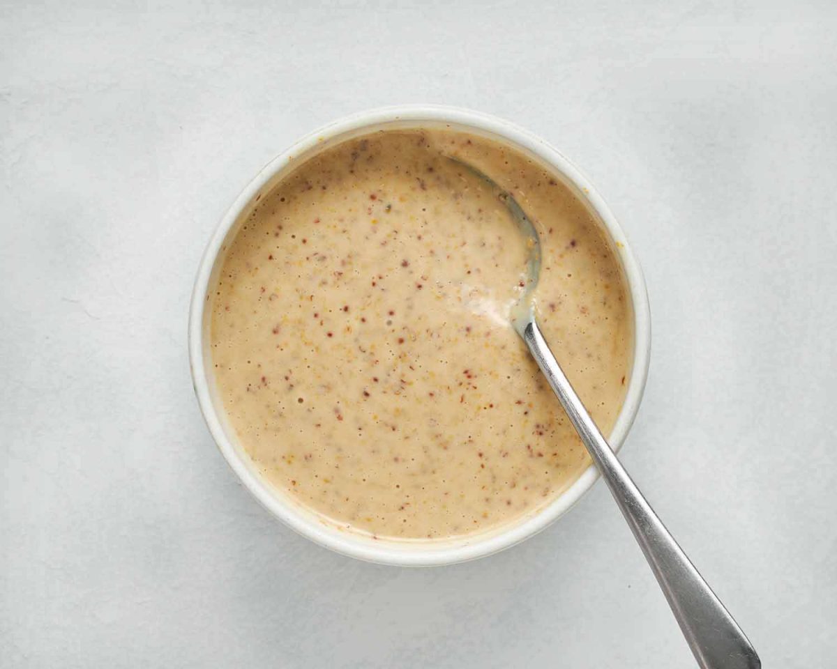 bowl of honey mustard sauce with a spoon.