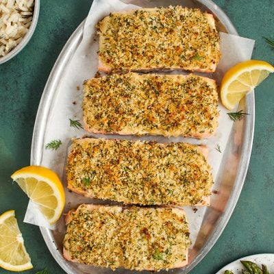baked salmon on platter served with asparagus and rice
