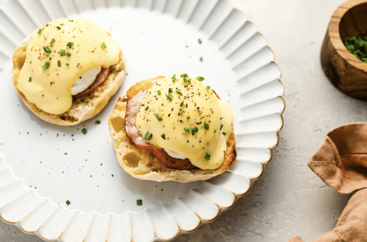 fully prepared eggs Benedict on white plate