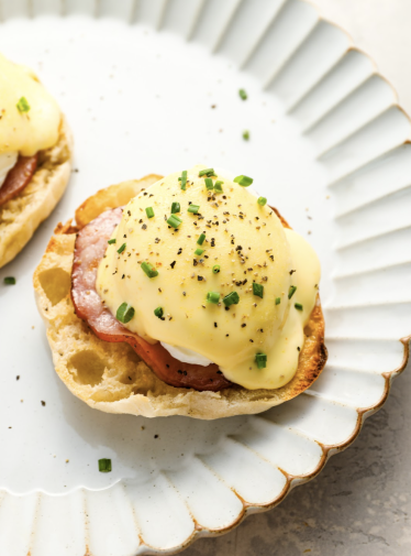 fully prepared eggs Benedict on white plate
