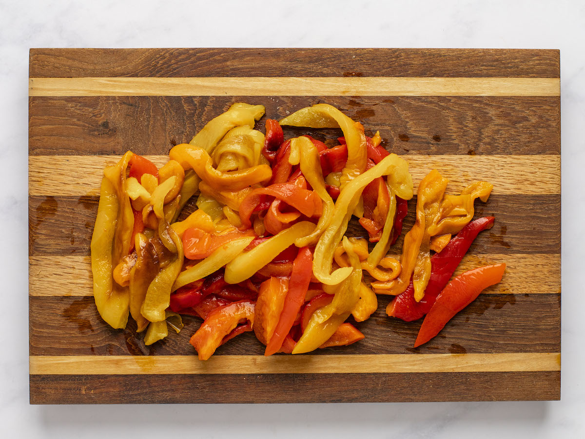sliced peppers on wooden cutting board.