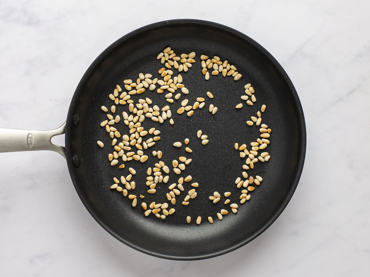pine nuts toasting in small skillet.
