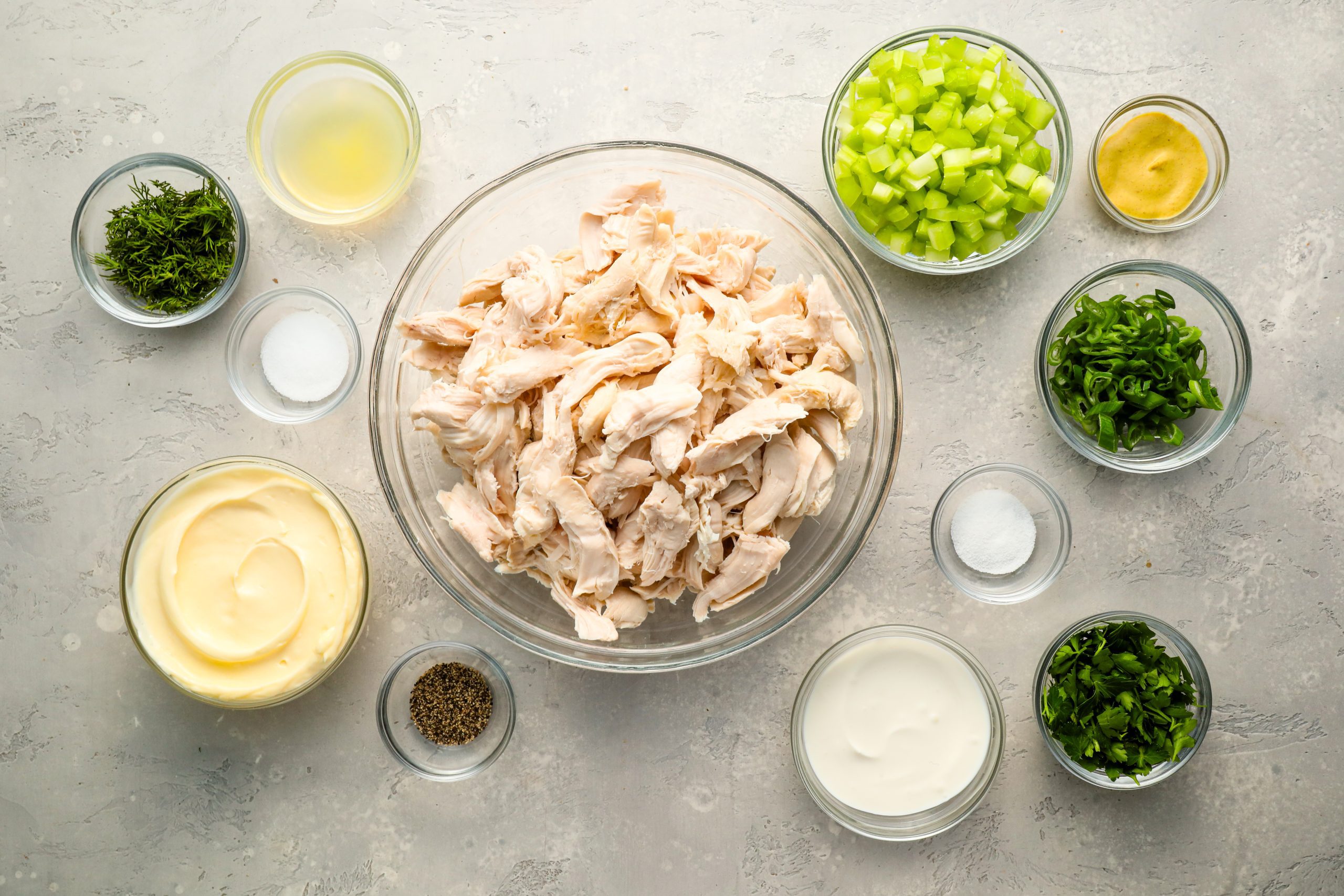 Chicken salad ingredients in bowls.