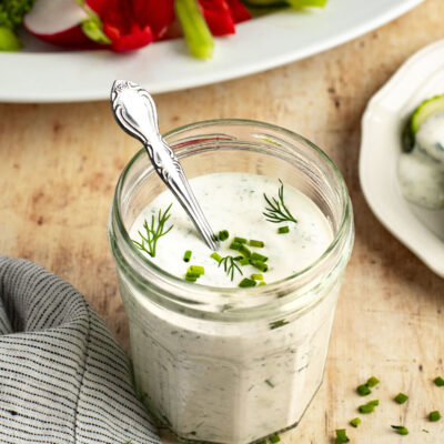 jar of ranch dressing with platter of crudites.