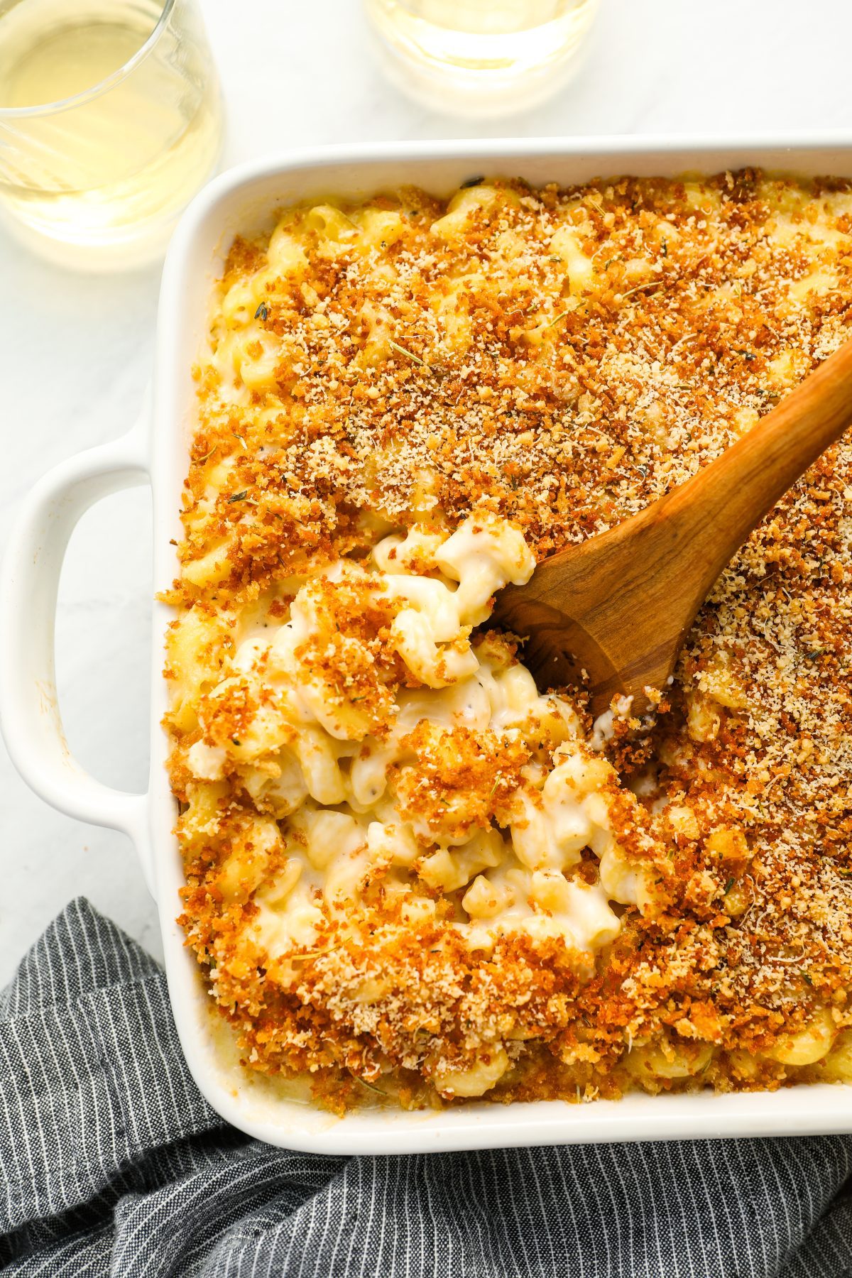 mac and cheese in baking dish with serving spoon
