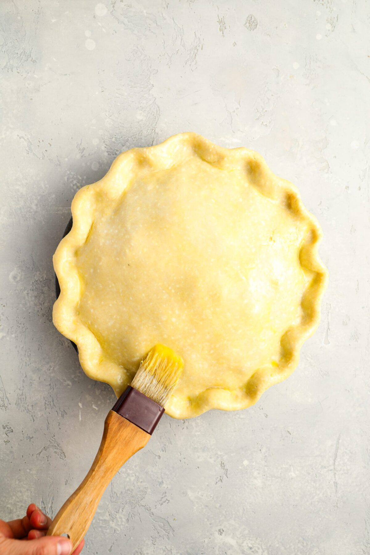 brushing top crust with beaten egg