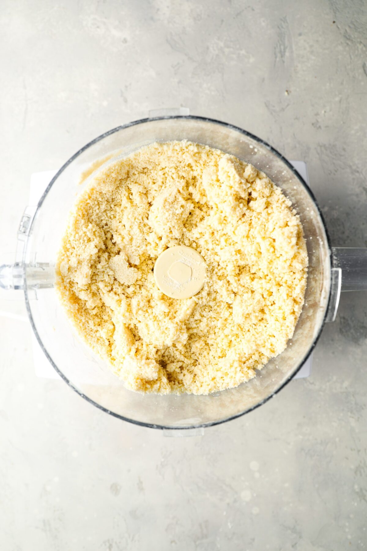 water combined with flour, sugar, salt, butter and baking powder in bowl of food processor