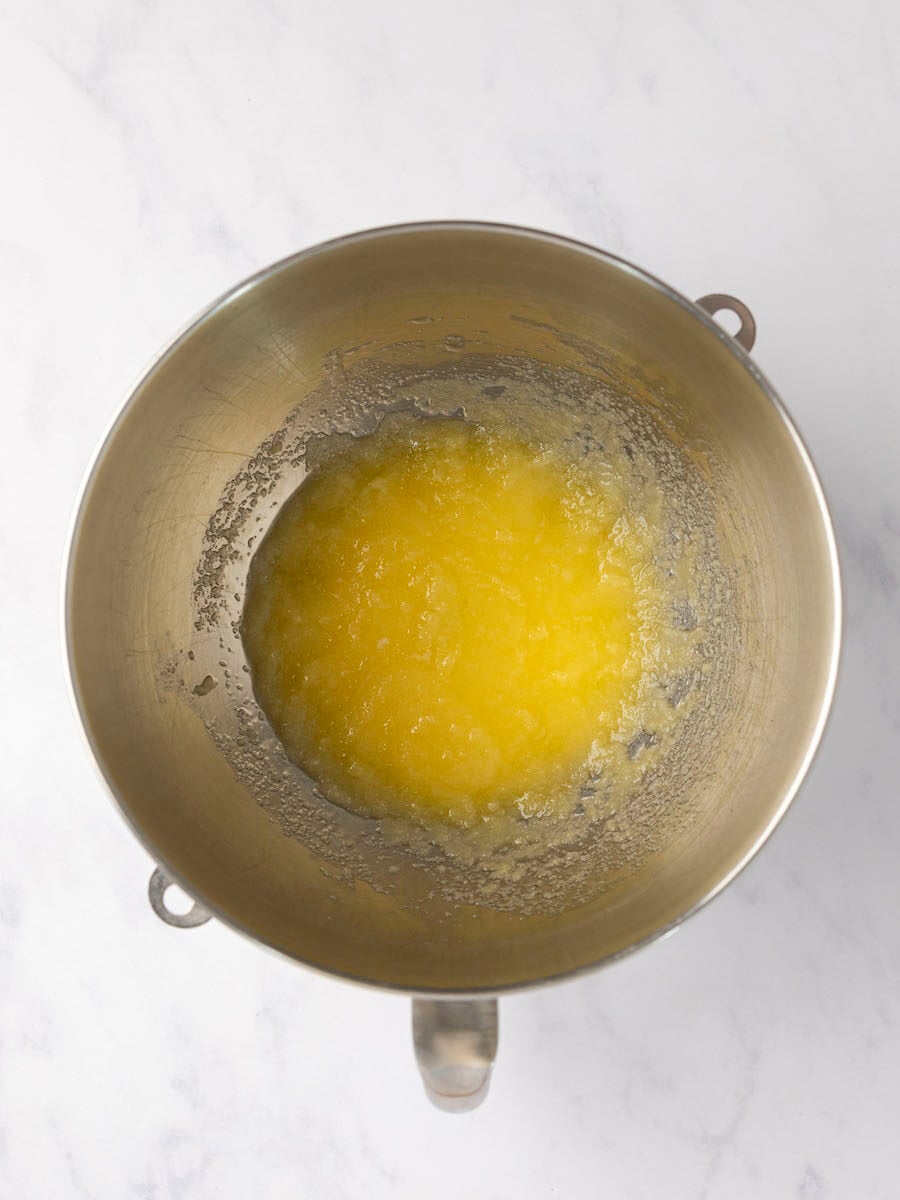 melted butter and sugar mixed together in metal mixing bowl