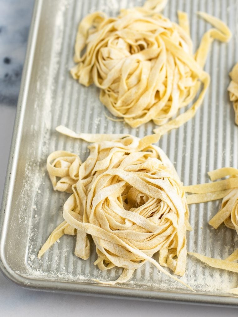 homemade pasta on baking sheet