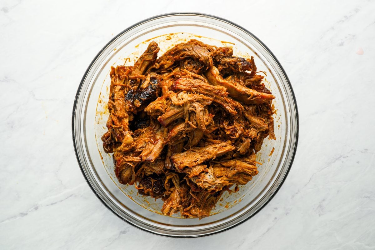 pork coated with BBQ sauce in bowl