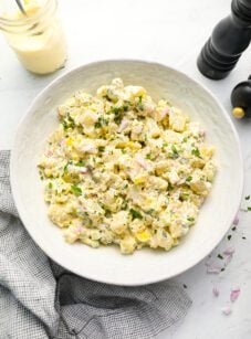 All-American potato salad in bowl with linen napkin.