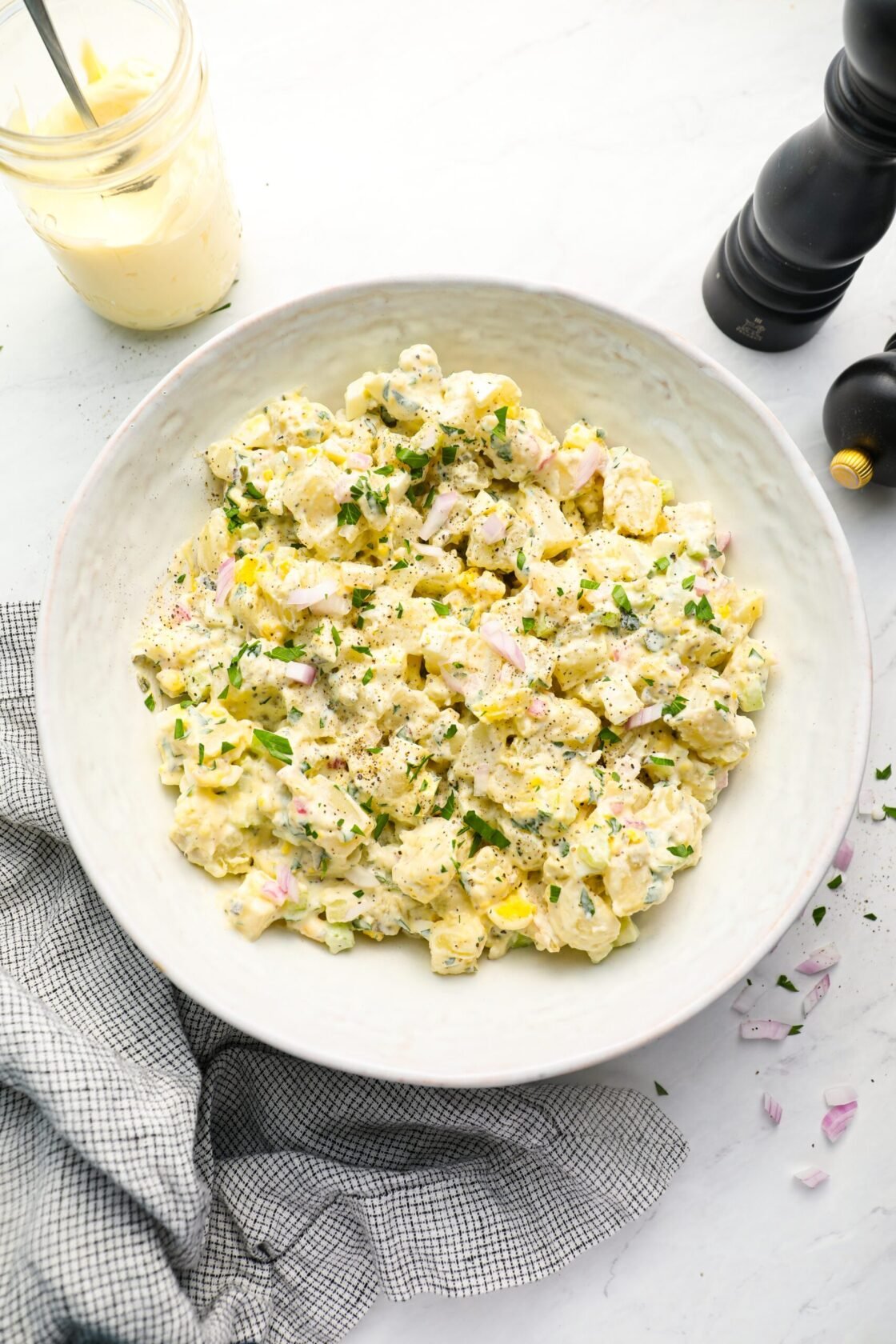 All-American potato salad in bowl with linen napkin.