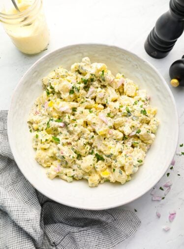 All-American potato salad in bowl with linen napkin.