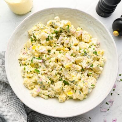 All-American potato salad in bowl with linen napkin.