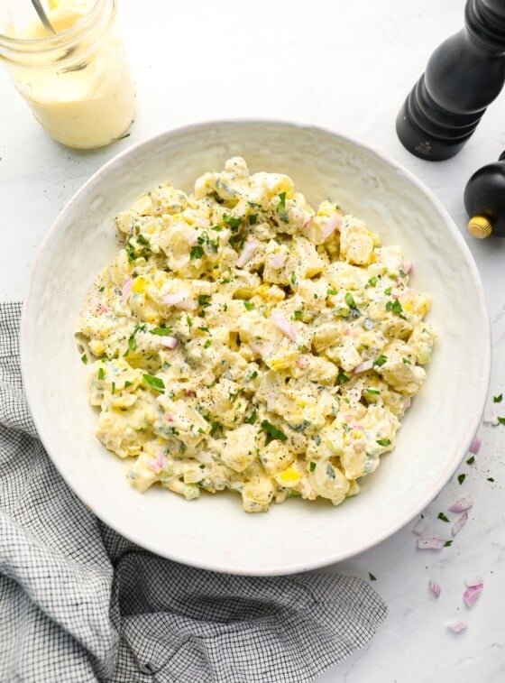 All-American potato salad in bowl with linen napkin.
