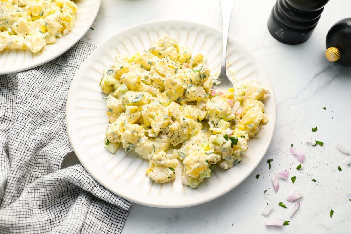potato salad on plate with fork and linen napkin