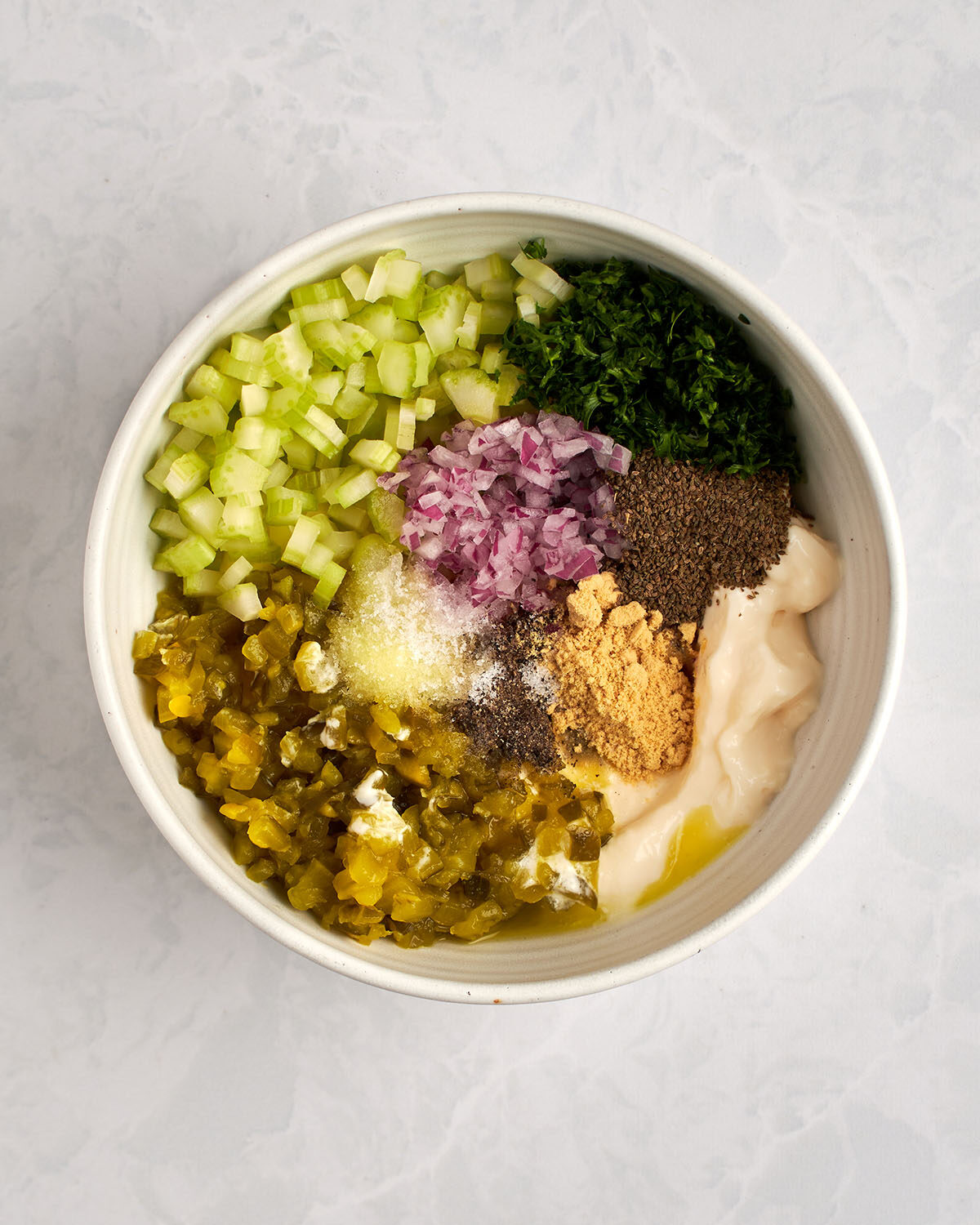 small mixing bowl celery, onion, relish, mayonnaise, dry mustard, celery seed, parsley, pepper, and ¾ teaspoon salt