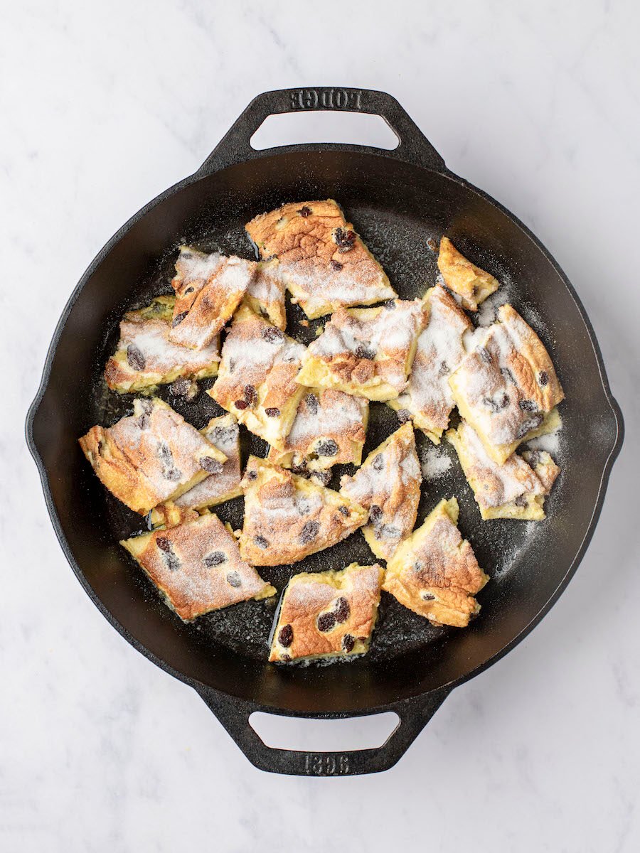 kaiserschmarrn pieces coated with granulated sugar in large non-stick skillet