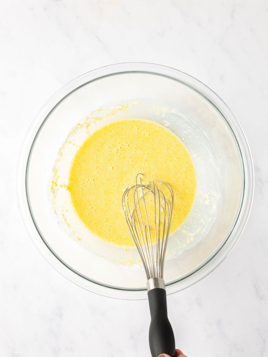 the egg yolks, milk, vanilla, and 1 tablespoon rum whisked together in large bowl