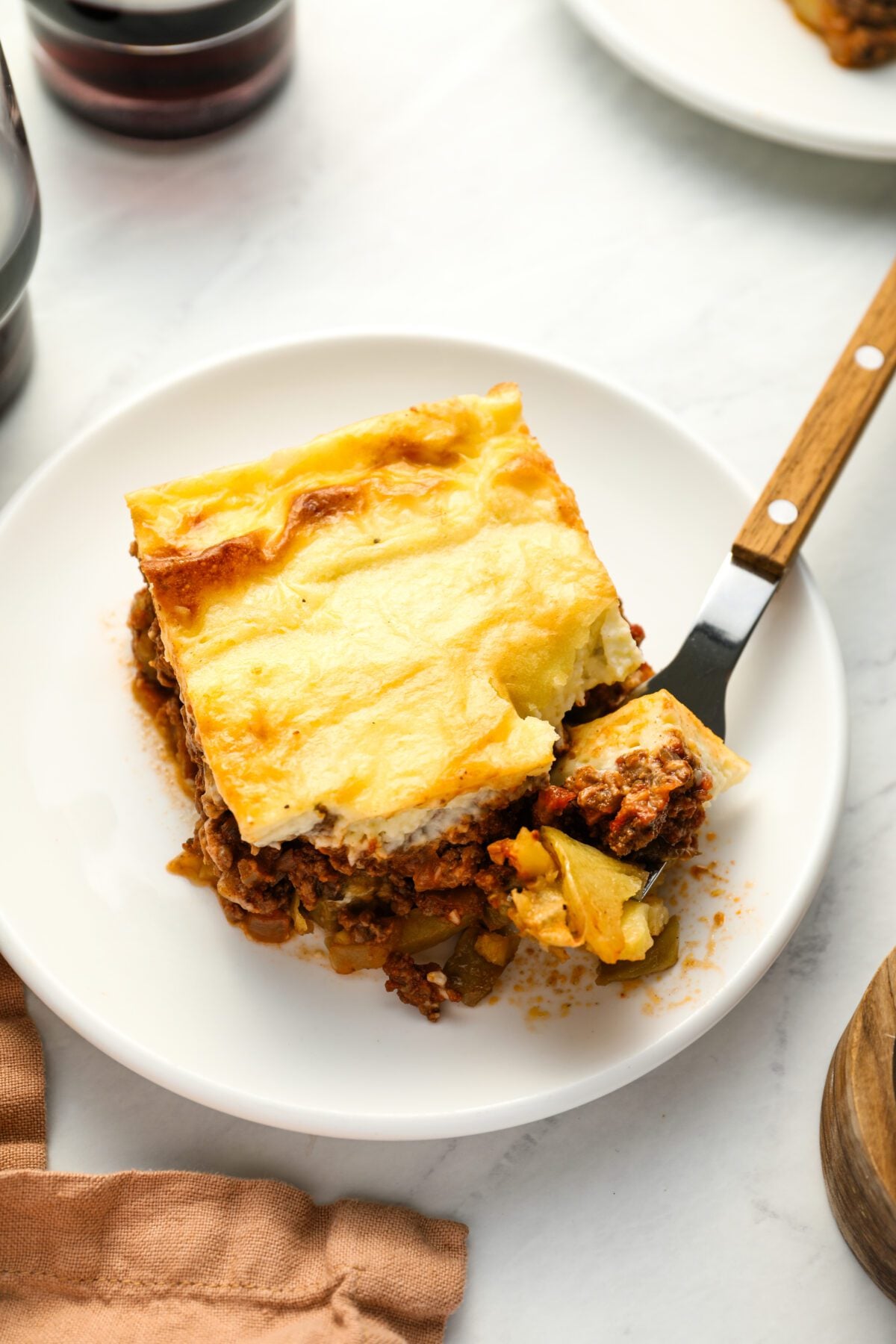 Slice of moussaka on plate.