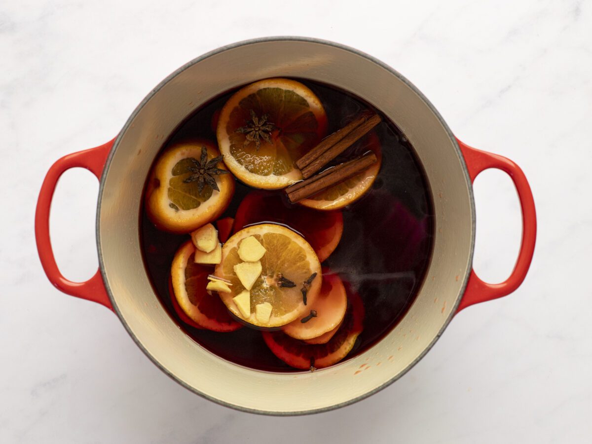 Wine, orange slices, brandy, honey, sugar, cinnamon, cloves, star anise, and ginger in a large saucepan.