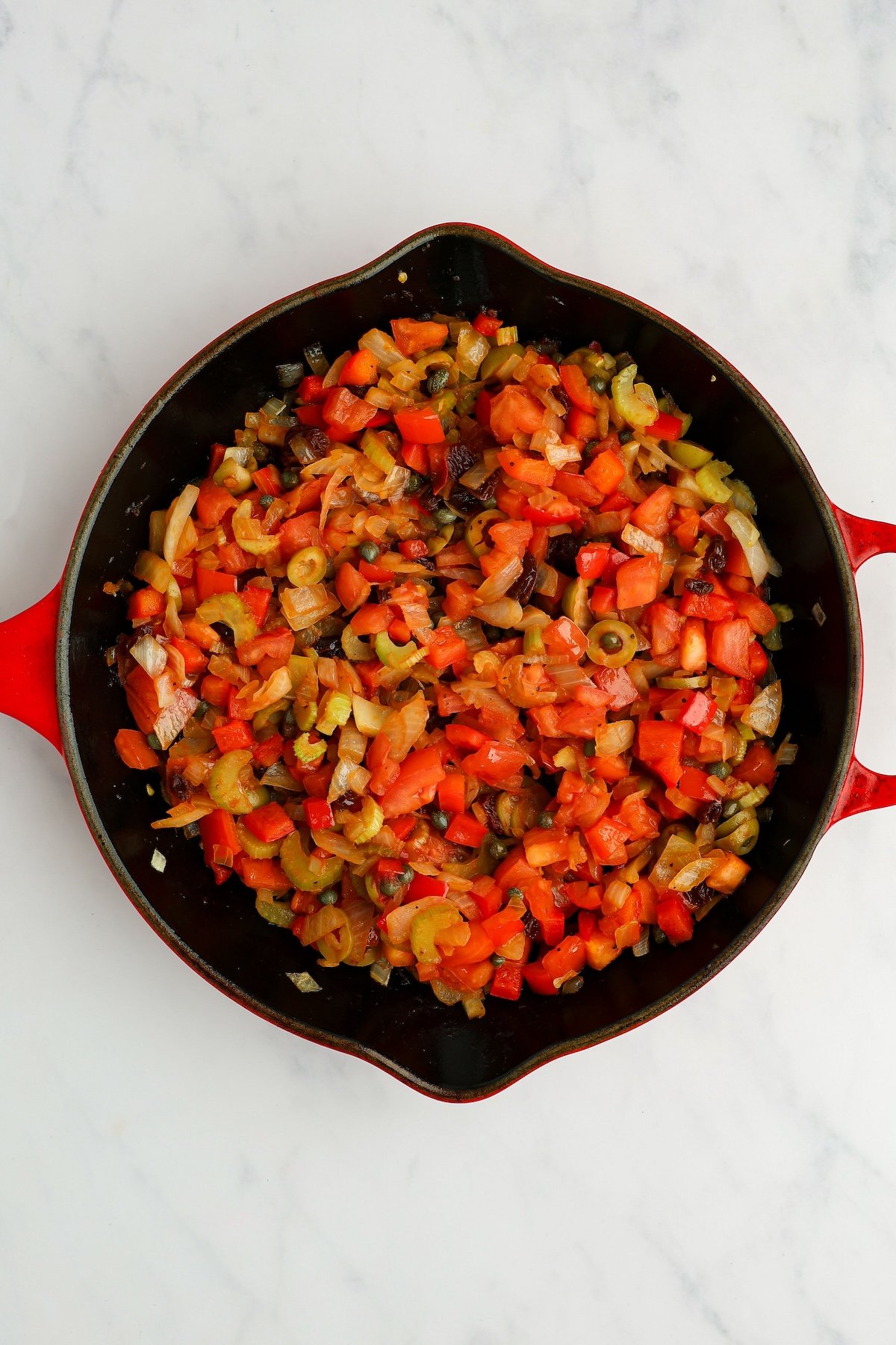 large skillet with cooked vegetable mixture and vinegar poured in