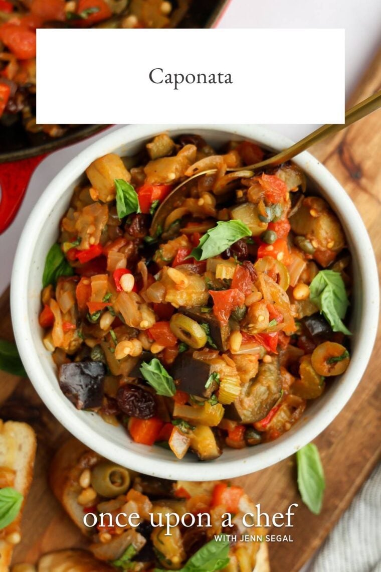 white bowl with caponata with caponata topped baguette slices nearby