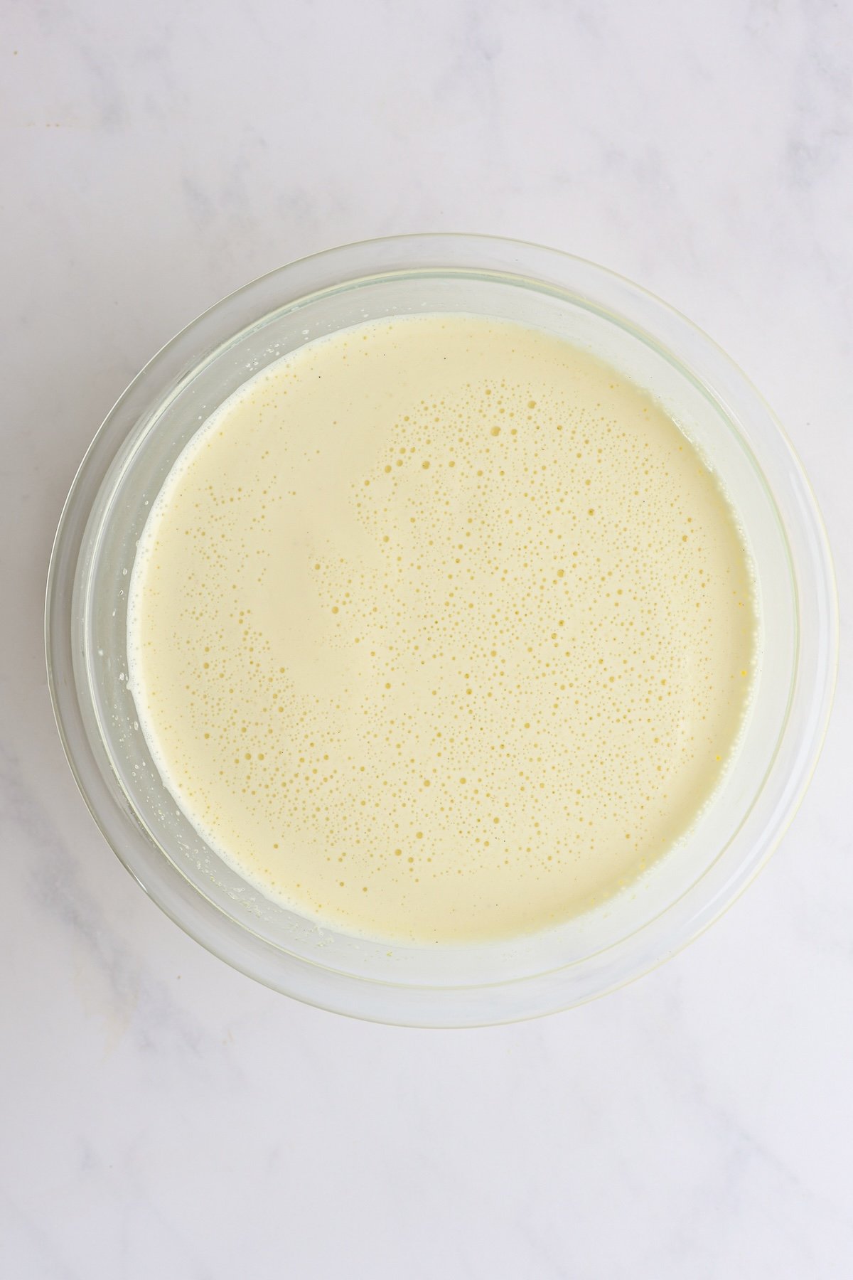 1/2 cup warm milk combined with sugar/egg mixture in glass bowl
