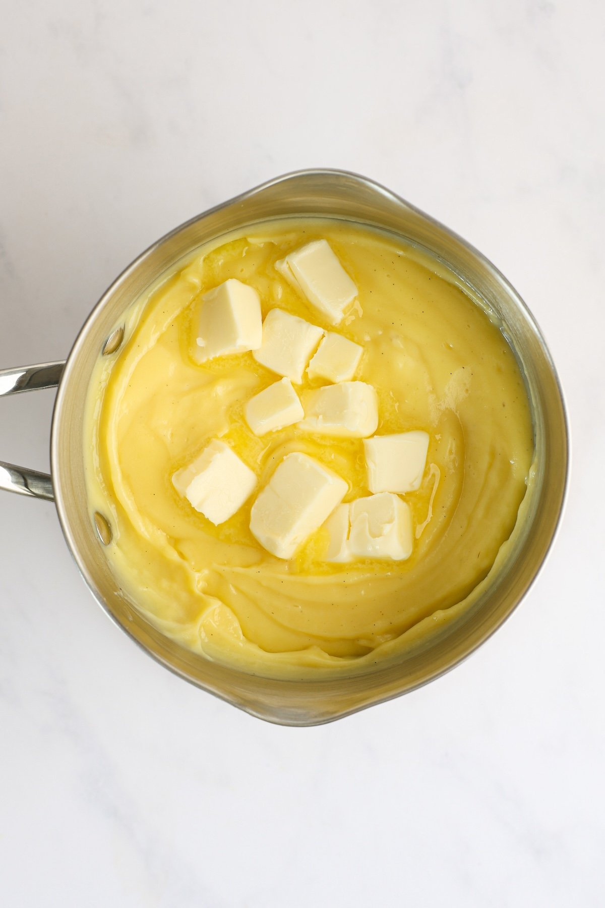 butter and rum added to thickened mixture in saucepan