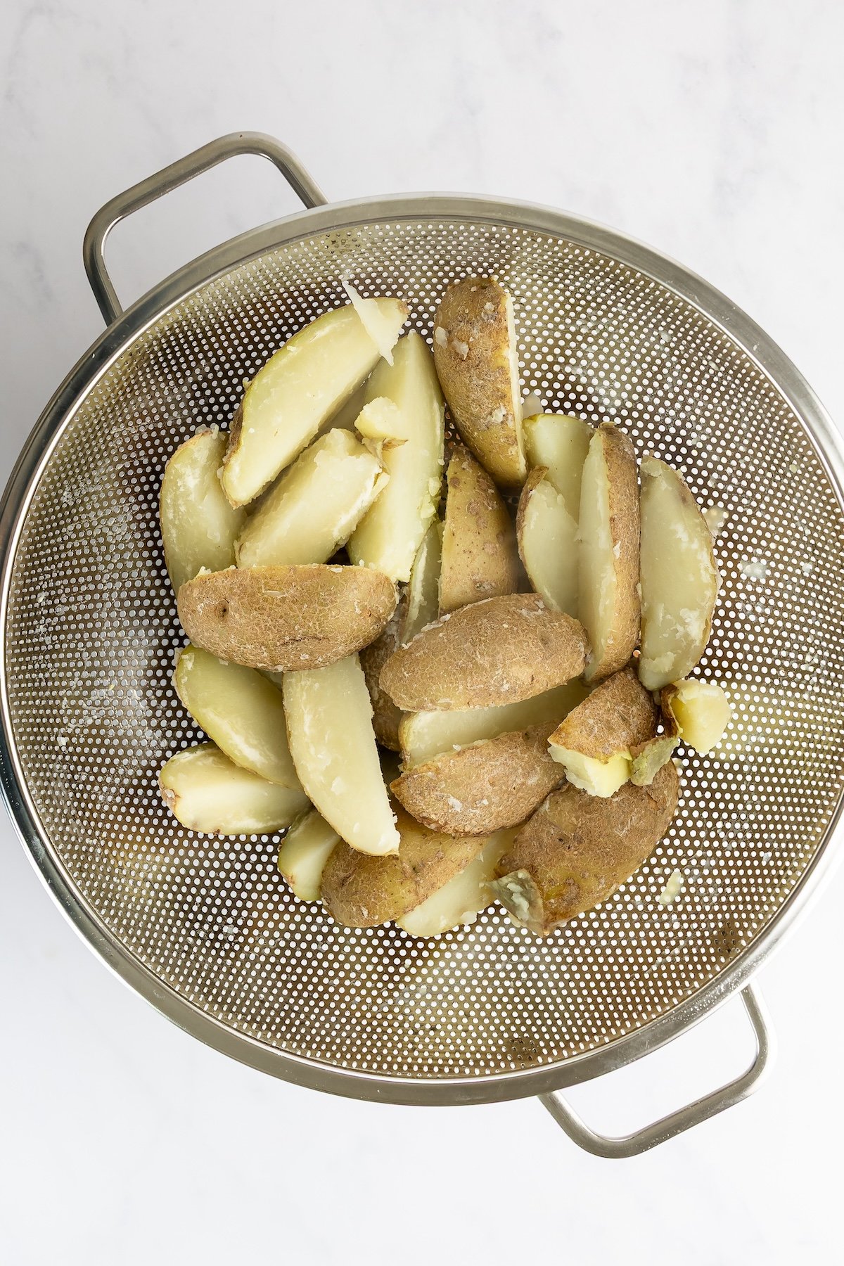 potato wedges in colander