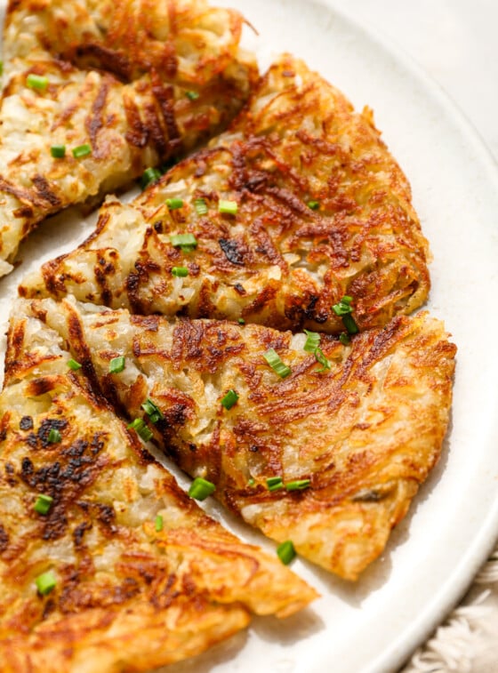 Sliced hash browns on white plate.