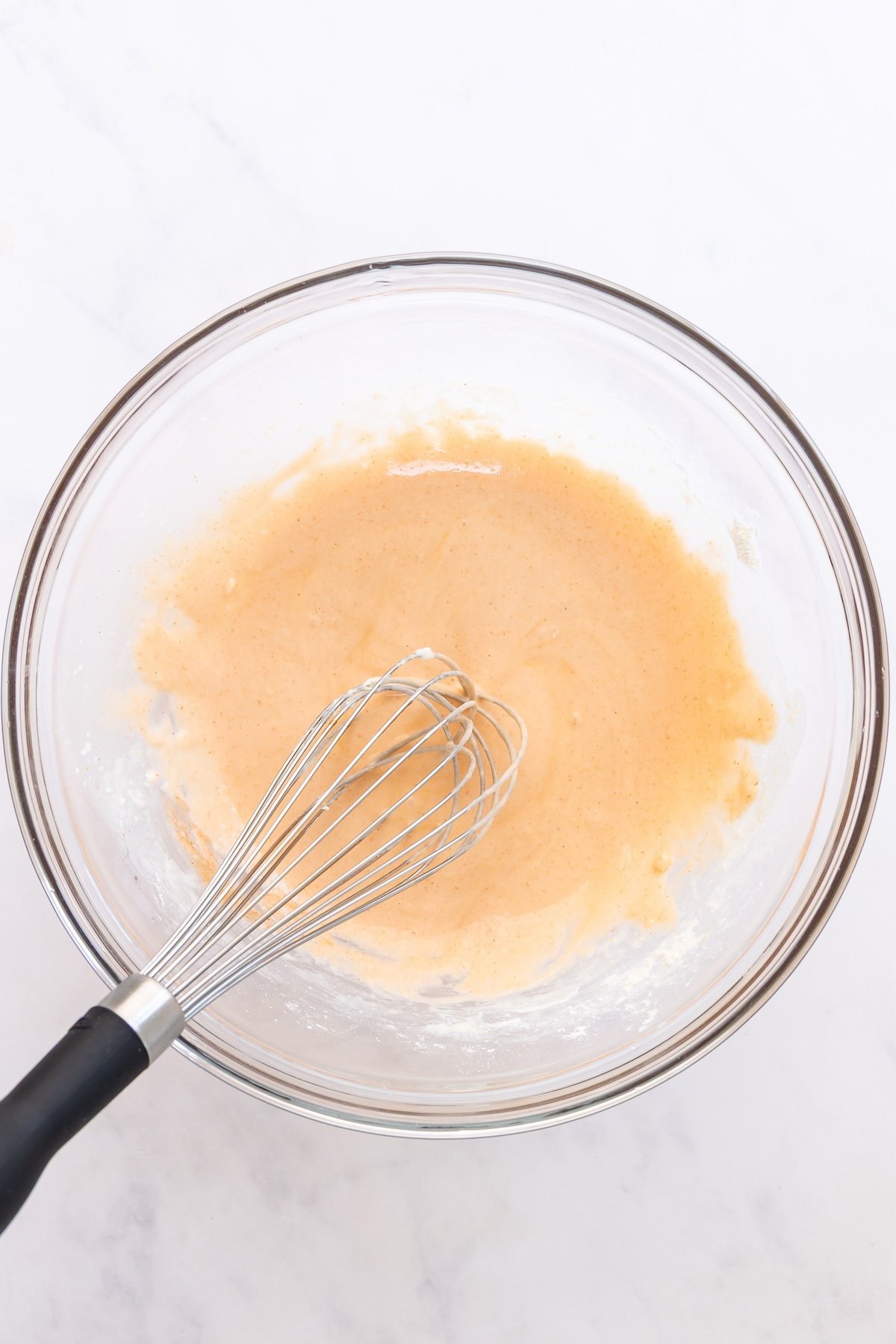 large bowl with milk and hot sauce added to cornstarch mixture