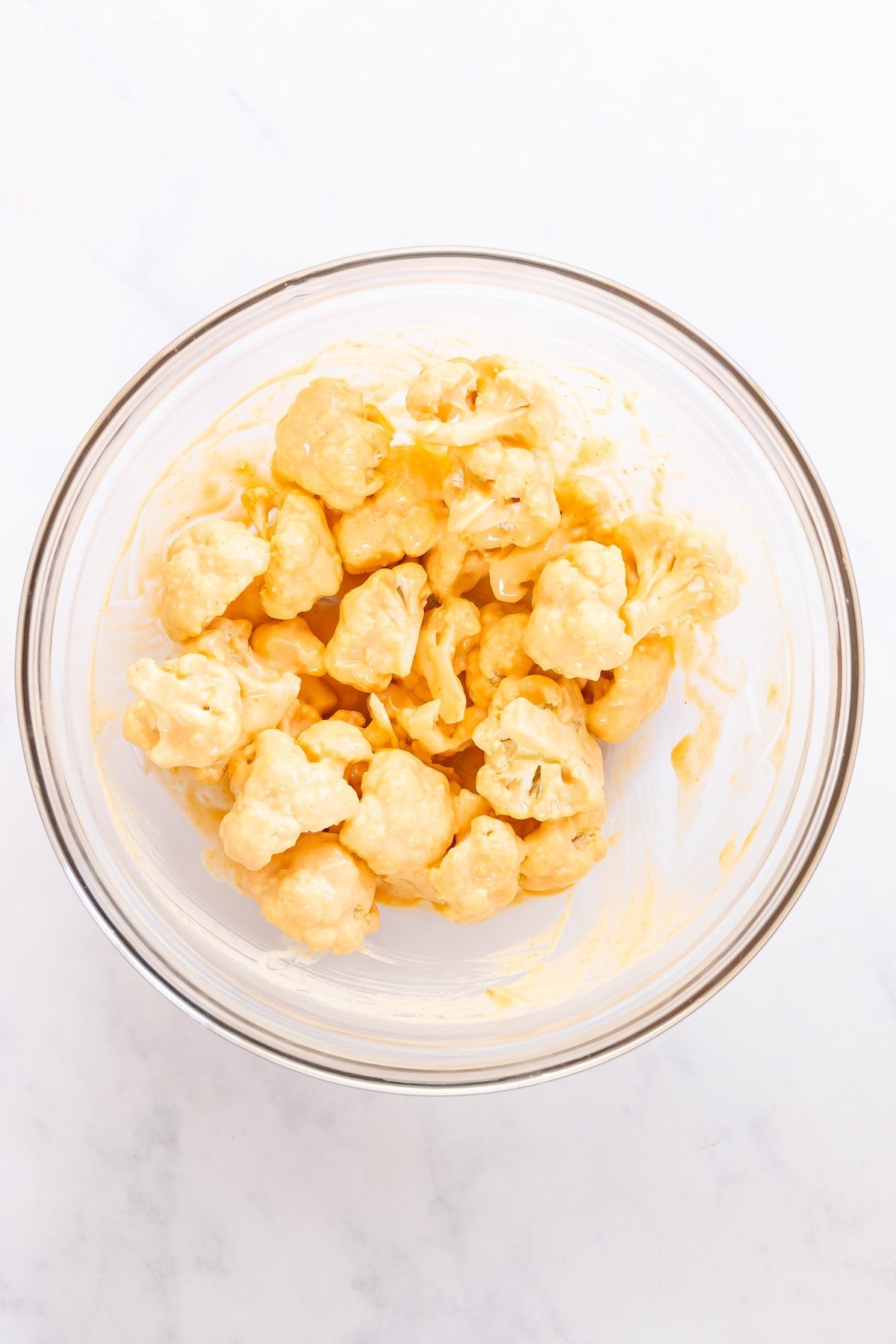 large bowl with cauliflower florets coated in batter
