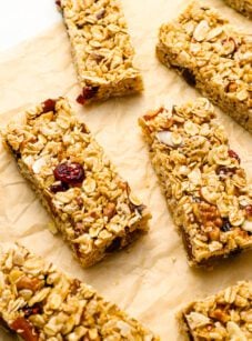 homemade granola bars with bowl of nuts.
