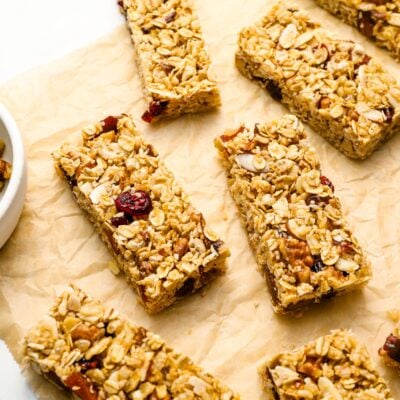 homemade granola bars with bowl of nuts.