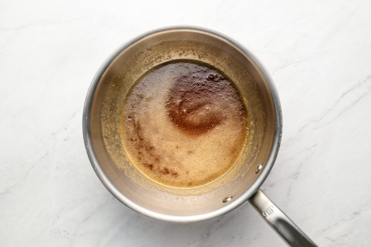 small saucepan with honey, brown sugar, butter, vanilla extract and salt after being boiled