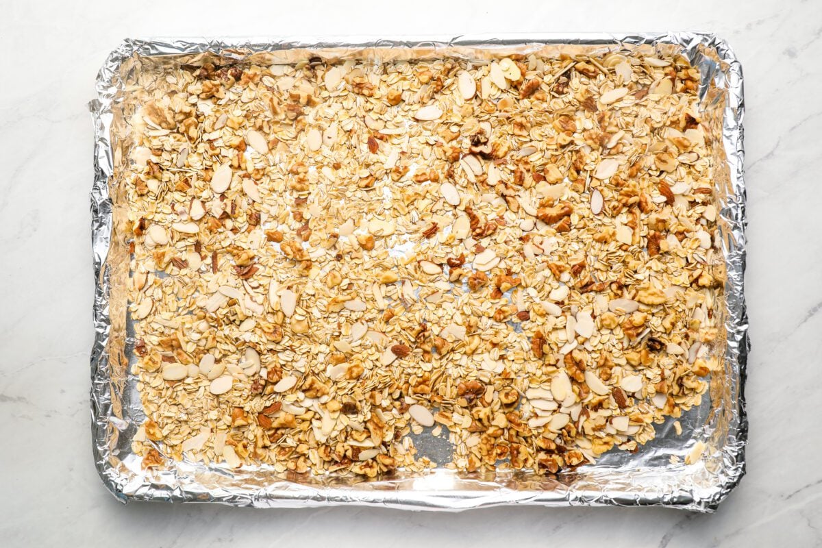 toasted oats and nuts on foil-lined baking sheet