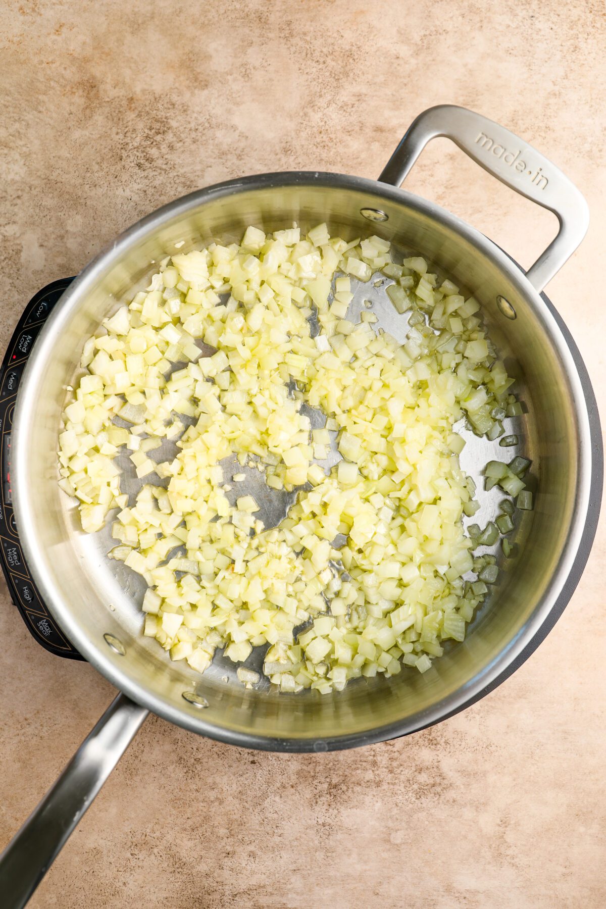 large skillet with onion and garlic