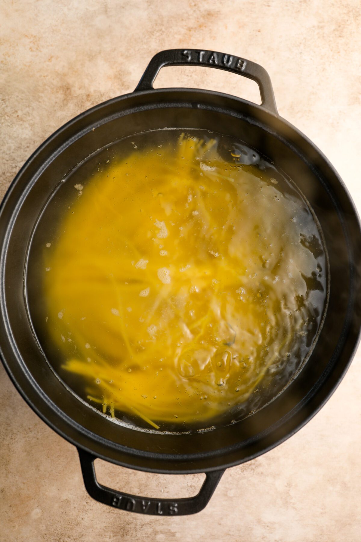 spaghetti cooking in dutch oven