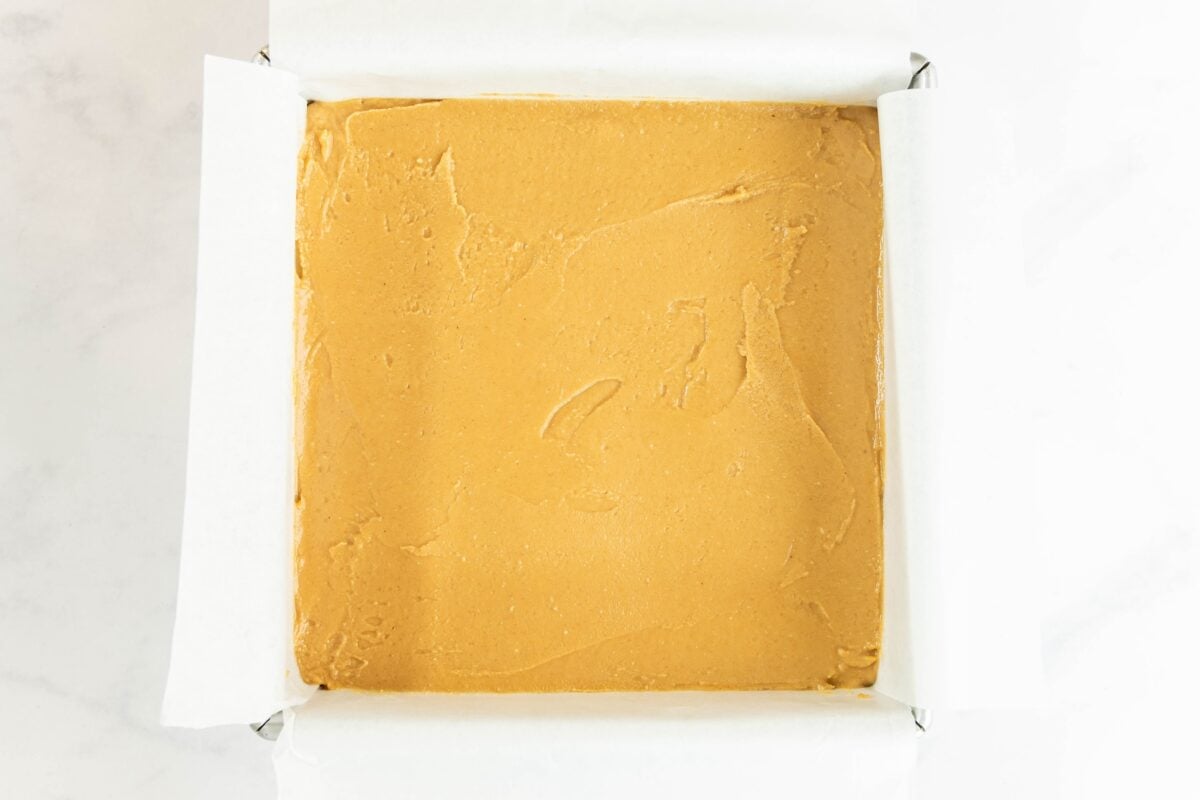peanut butter fudge spread into parchment-lined pan