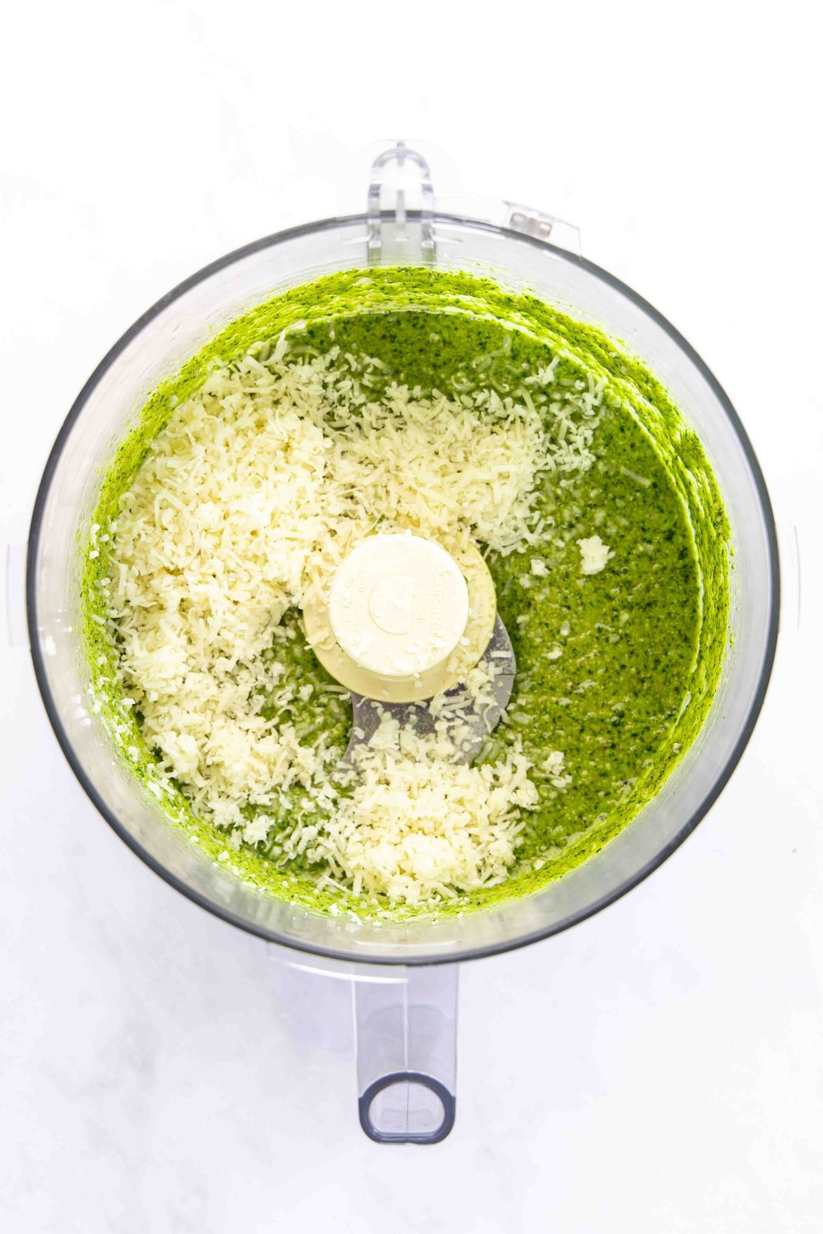 cheese added to pesto mixture in food processor
