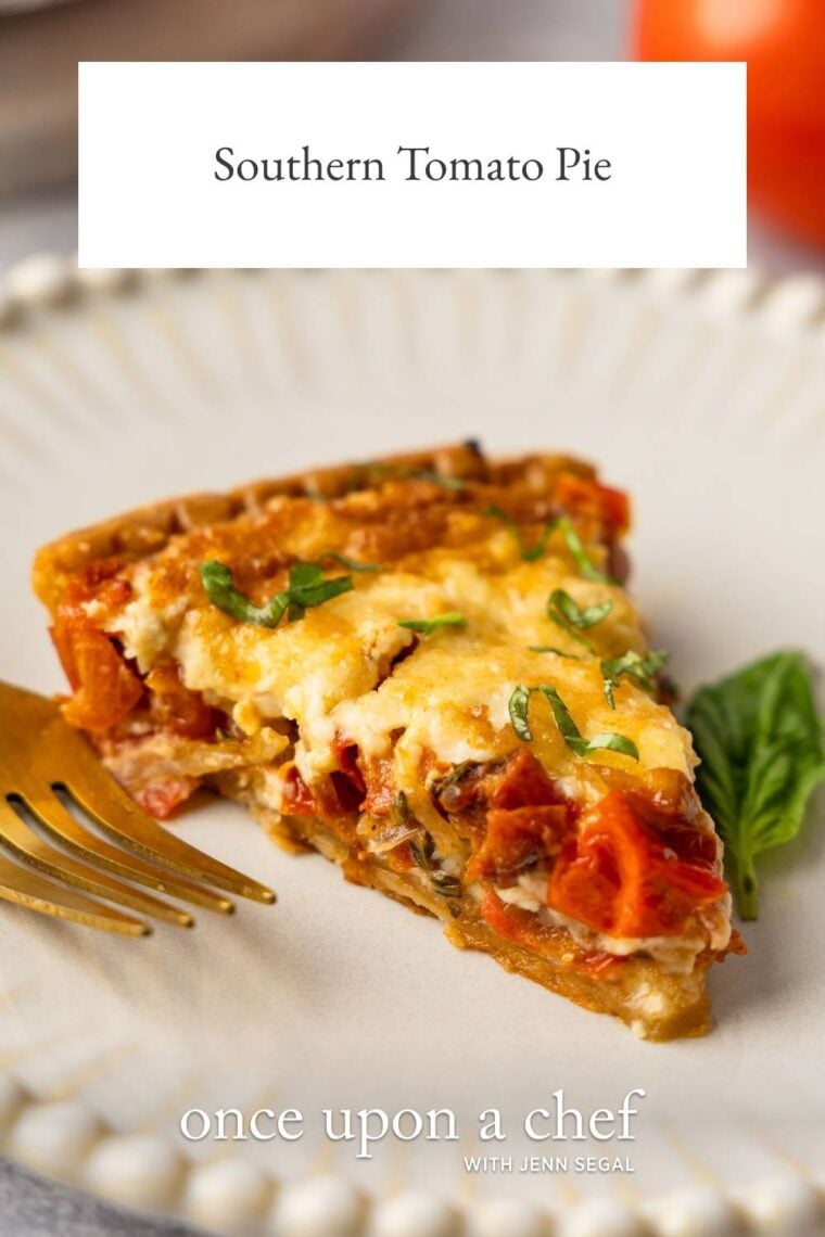 slice of southern tomato pie on white plate with fork